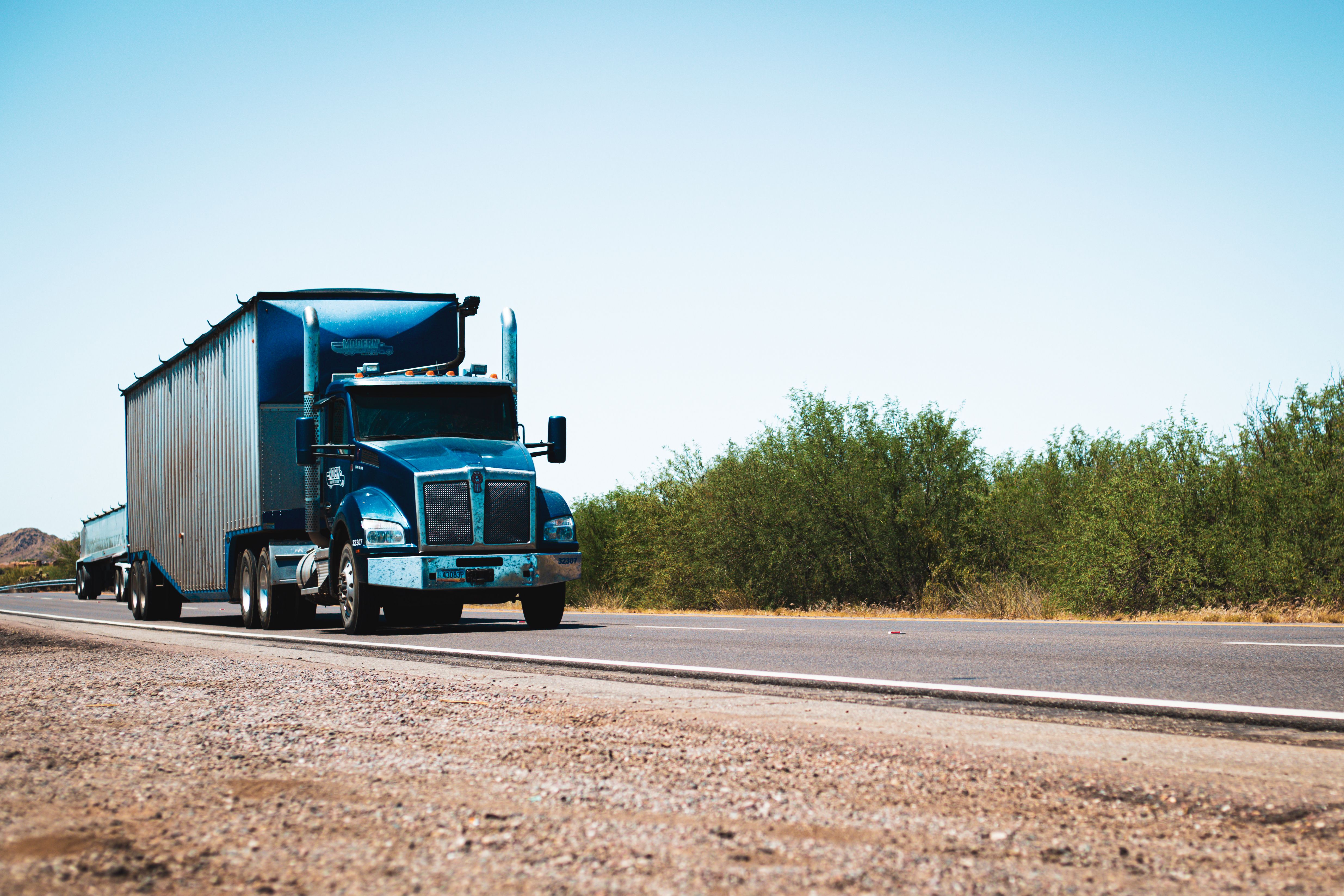 Full truckload semi-truck loaded with commercial cargo on the highway