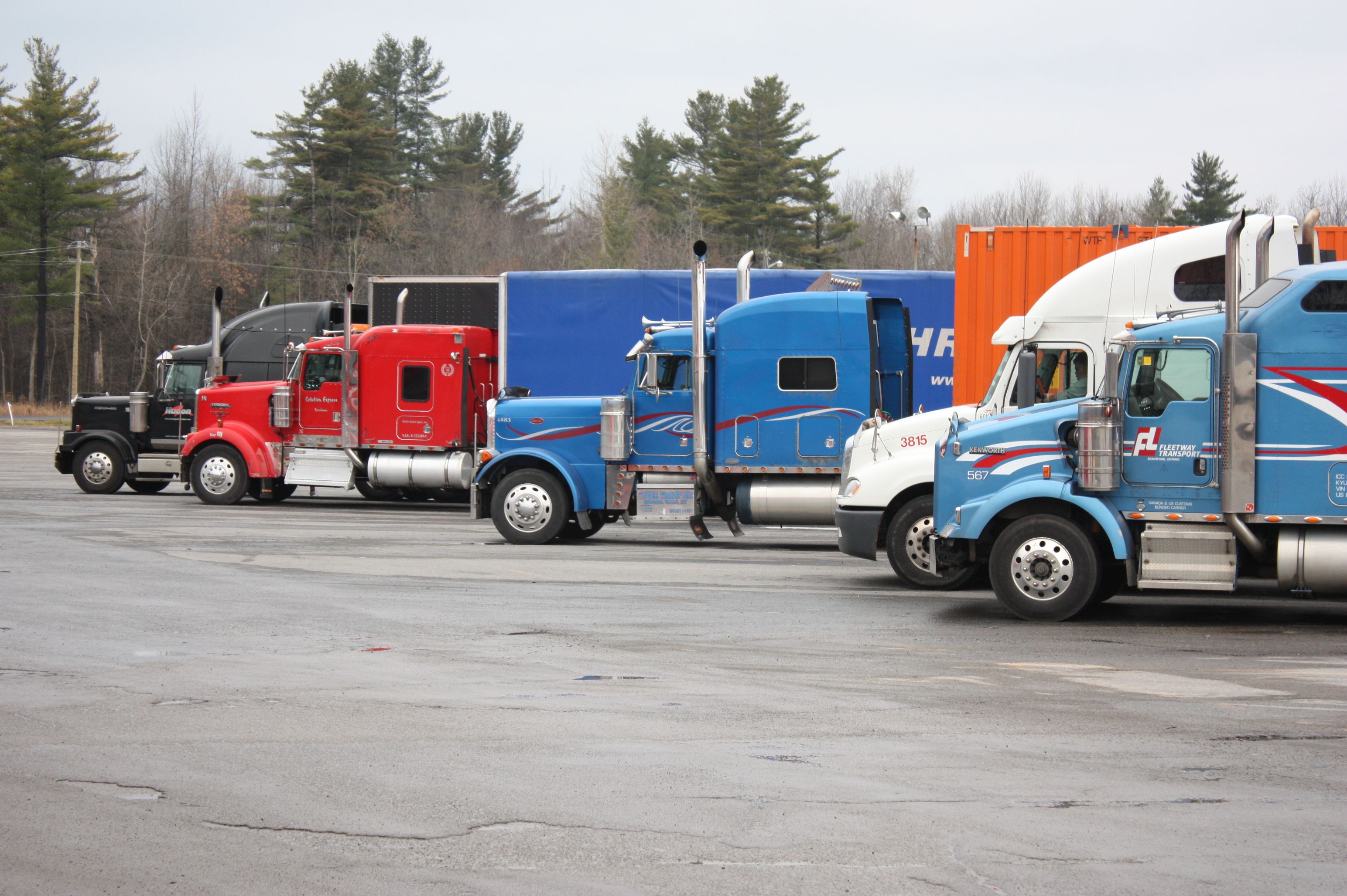 Freight trucks lined up at a logistics yard ready for interstate transport